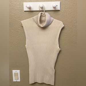 Cream sleeveless turtleneck